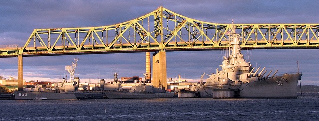 WWII Grey Battleships under steel bridge
