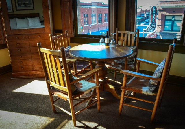 Table and chairs and view of street from Bonnie and Clyde Suite at Stockyards Hotel.