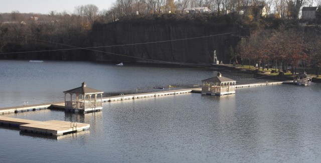 Cliff of brownstone ring a lake with floating docks and gazebos. Brownstone Discovery Park, Portland CT
