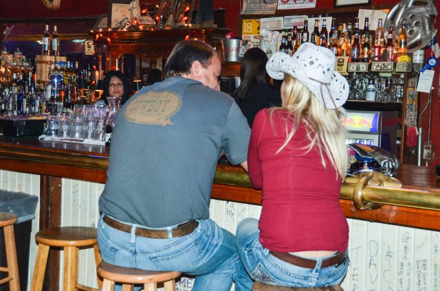 Couple sits on bar stools at White Elephant Saloon.