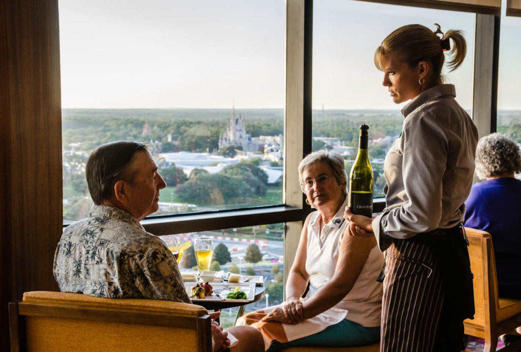 Waitress with wine bottle, couple dining with view of the Magic Kingdom. | California Grill | Disney World