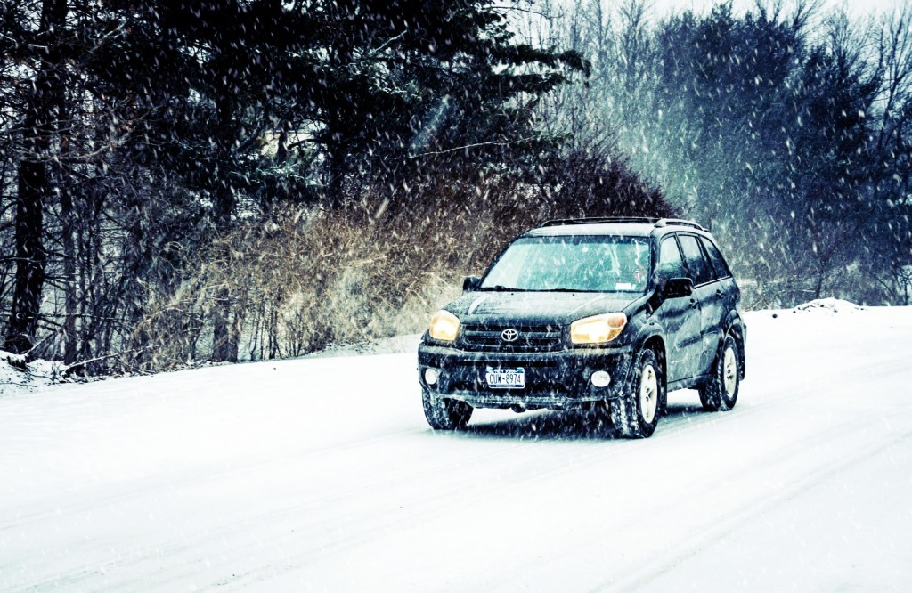 Toyota Rav 4 driving in a blizzard, hope there's a winter car survival kit in the car.