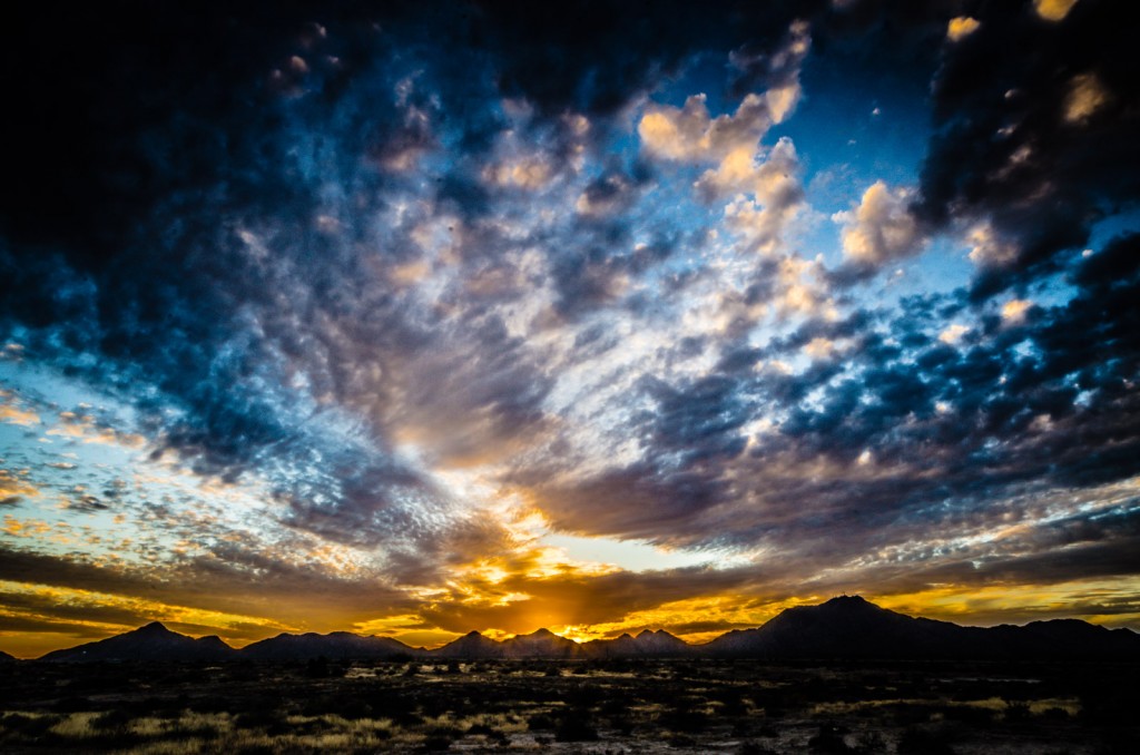 A breathtaking sunset over open roadside land in Arizona.