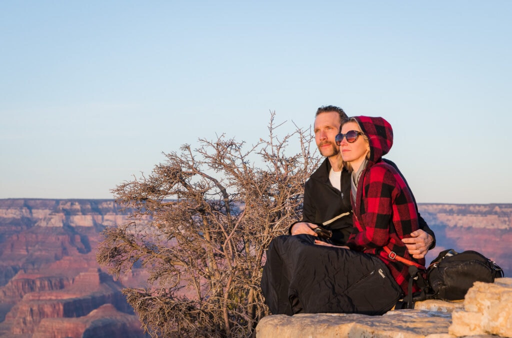Couple admires Grand Canyon sunset.