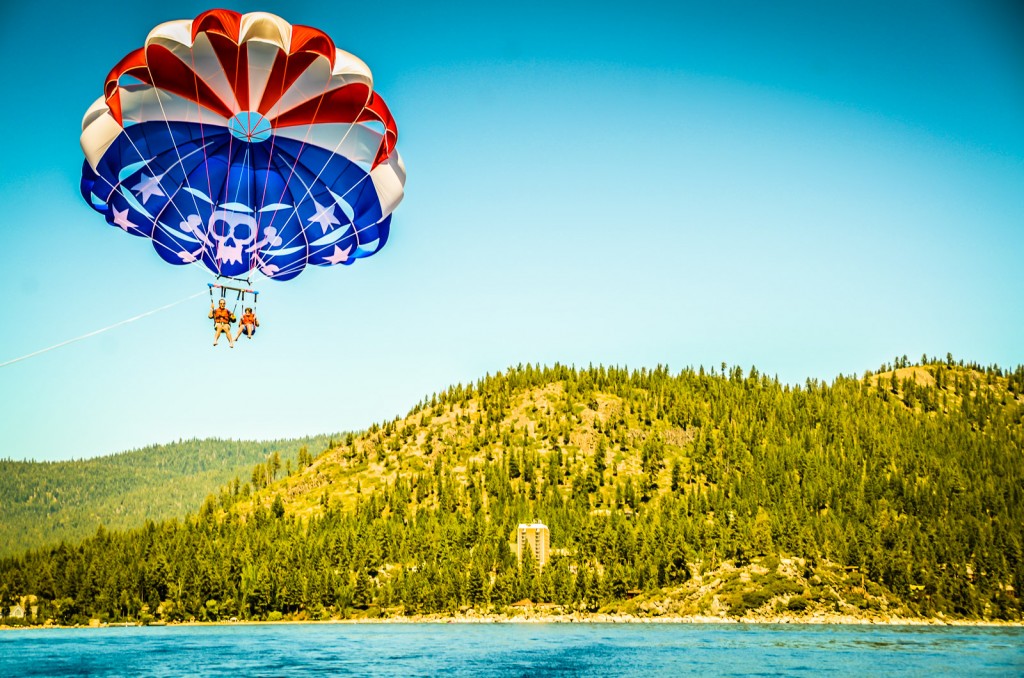 Mother and child parasail over Lake Tahoe.