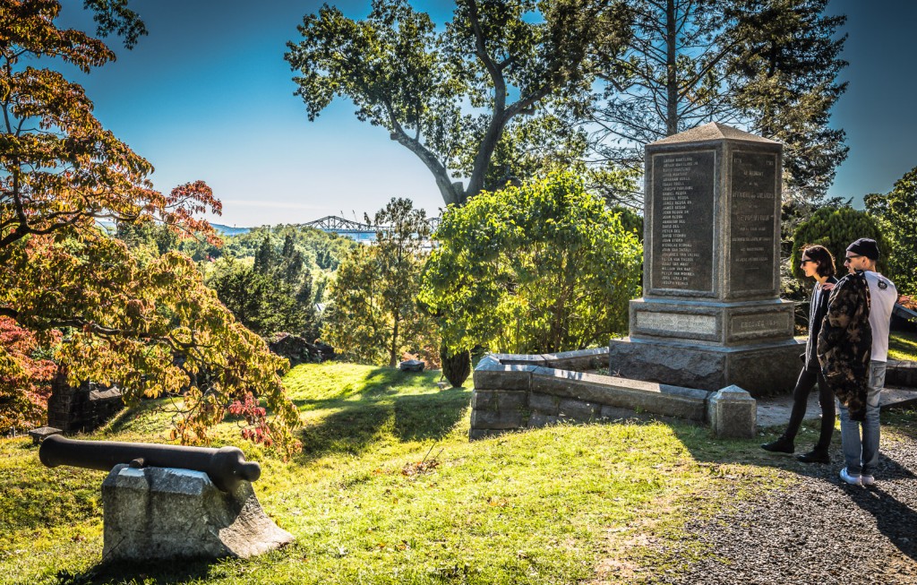 Couple on romantic getaway peer into landscape at Revolutionary War Monument - Sleepy Hollow Cemetery