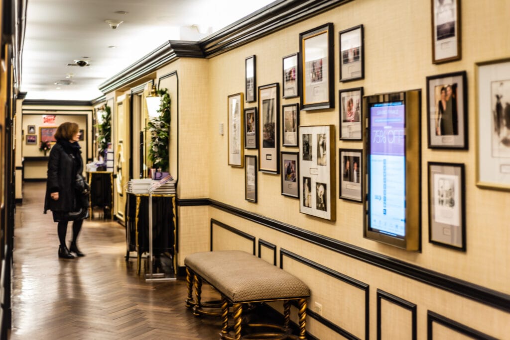 Woman eyes entrance to BG Restaurant in Bergdorf Goodman store.