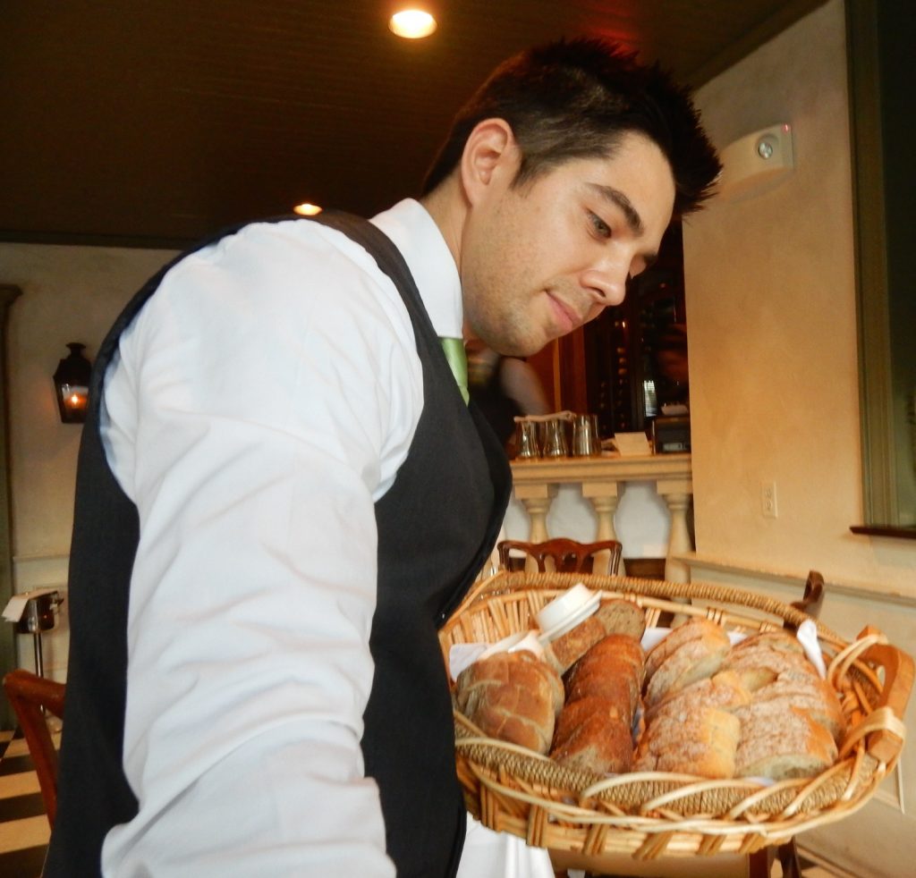 Waiter serves bread