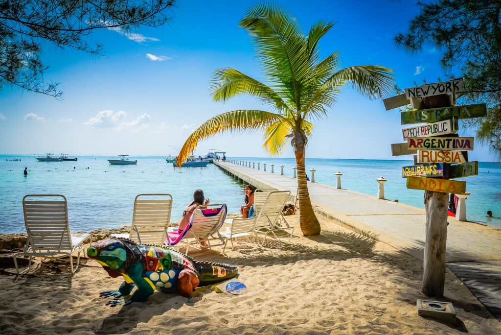 Tourists relaxing on chaise lounge at Rum Point in Grand Cayman