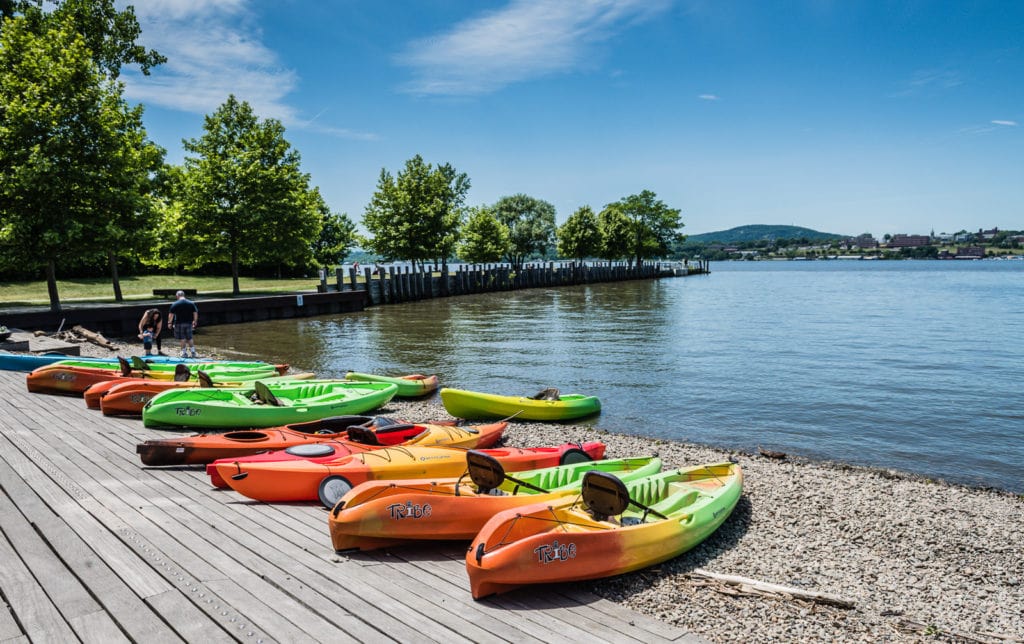 Kayaks lined up on Hudson River shore at Long Dock Park in Beacon, New York