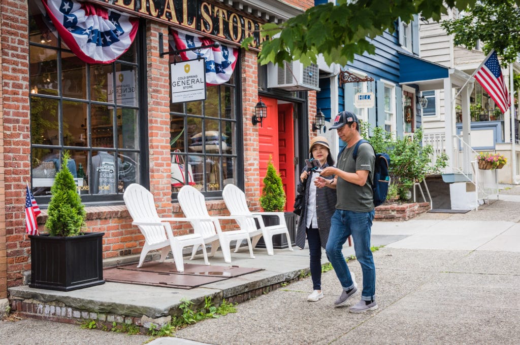 Visitors snap a selfie in front of Cold Spring General Store in Cold Spring NY.