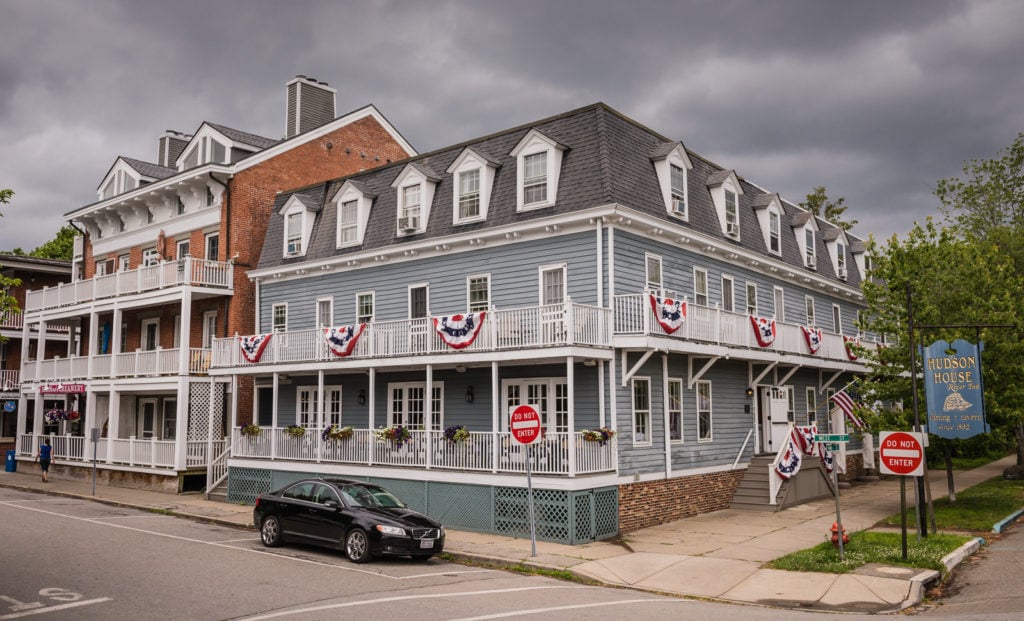 Flag festooned exterior of historic hotel Hudson House Inn in Cold Spring, New York.