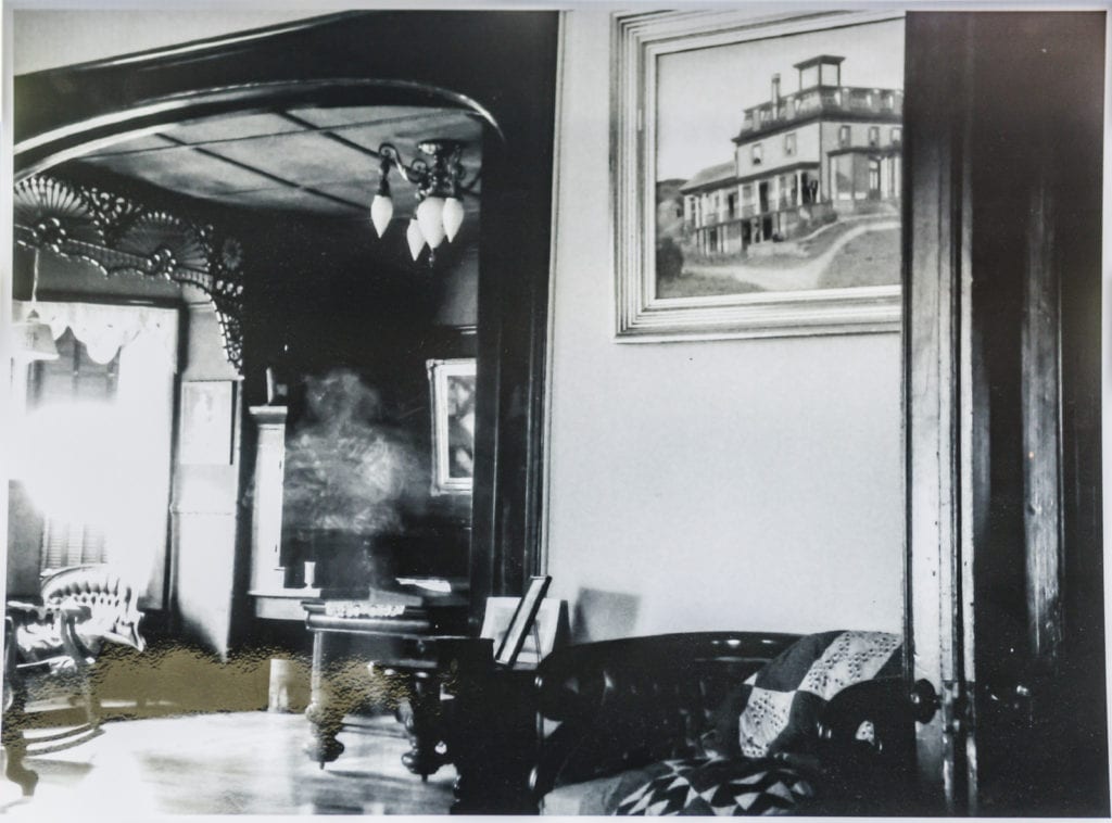 Black and white photo of Dr Best House interior that appears to show a ghost.