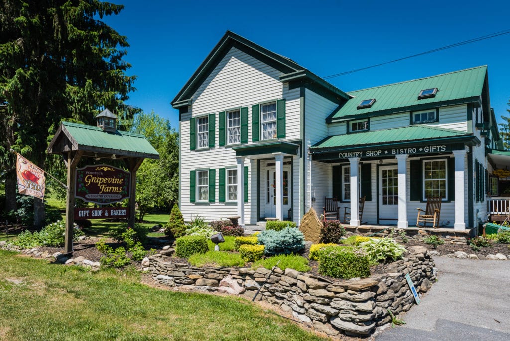 Front exterior of white farmhouse at Grapevine Farms in Schoharie NY.