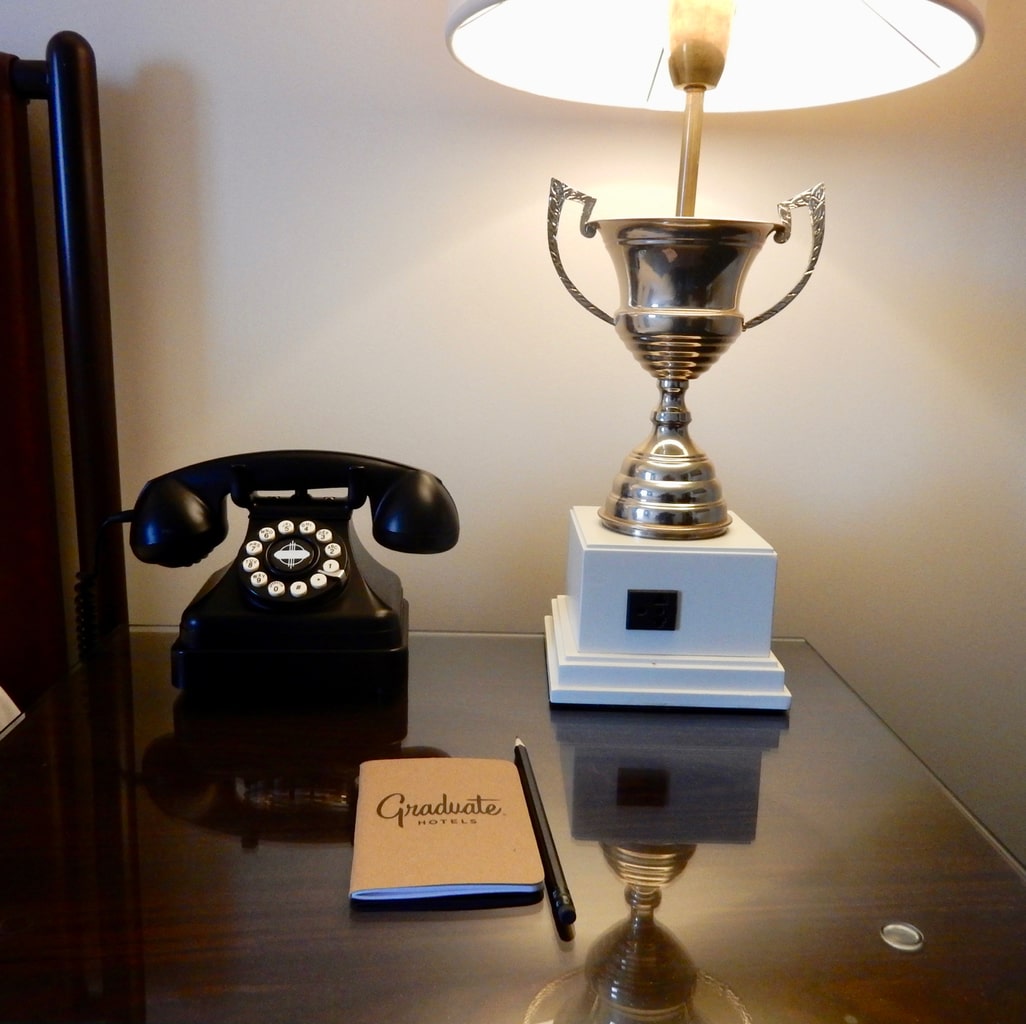 Rotary phone trophy lamp in guest room at The Graduate Charlottesville hotel. 