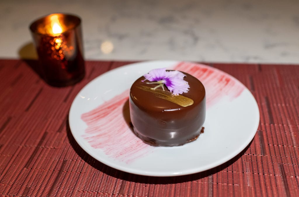 Mini chocolate cake decorated with pansy flower at Grand Tavern in St. Louis MO.