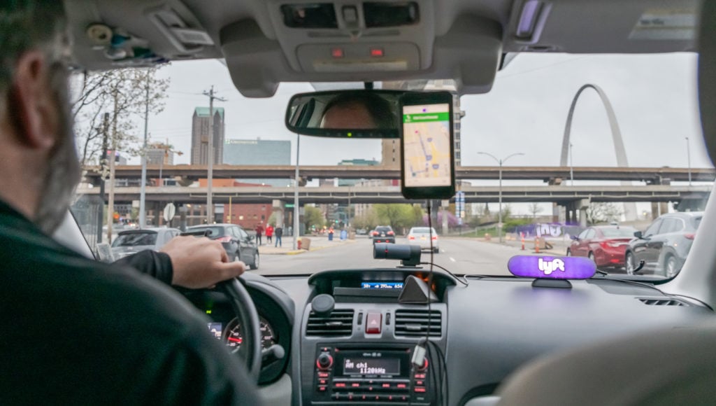 St Louis Arch seen through front window of Lyft vehicle.