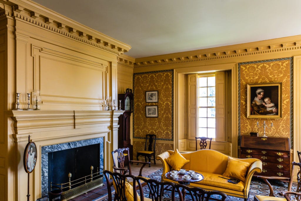 Schuyler Mansion interior room with yellow decor and flock wallpaper.