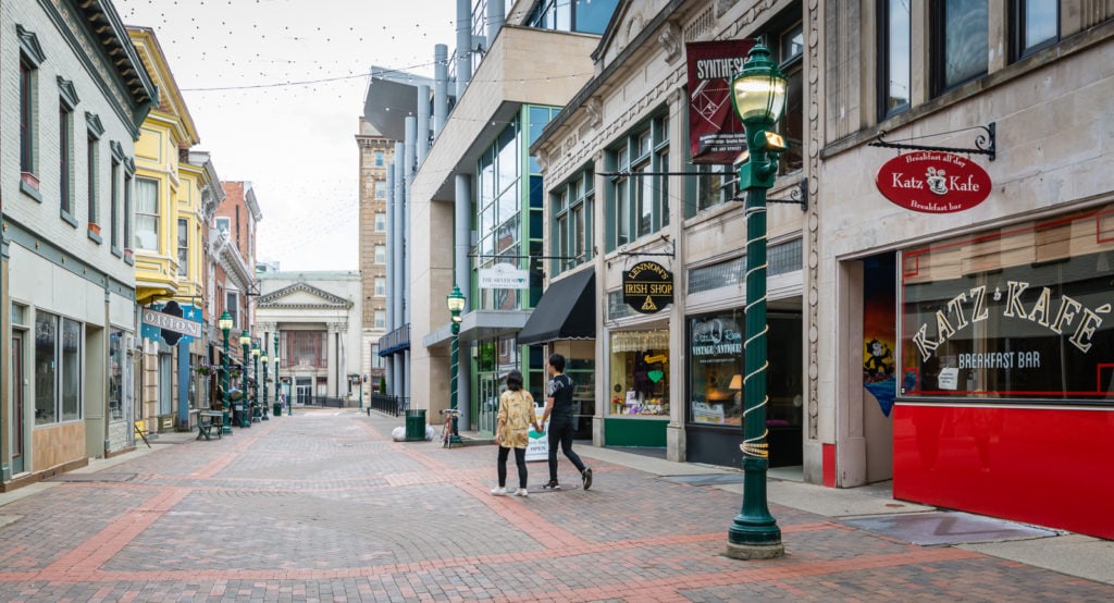 Couple walks holding hands in downtown Schenectady NY