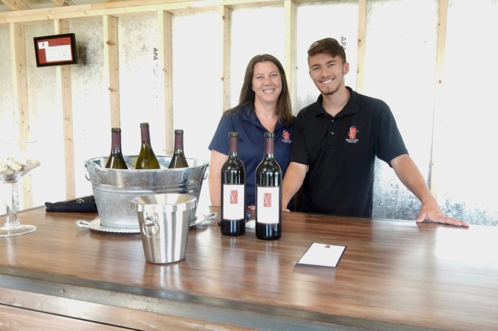 Mother-son owners of vineyard in tasting room