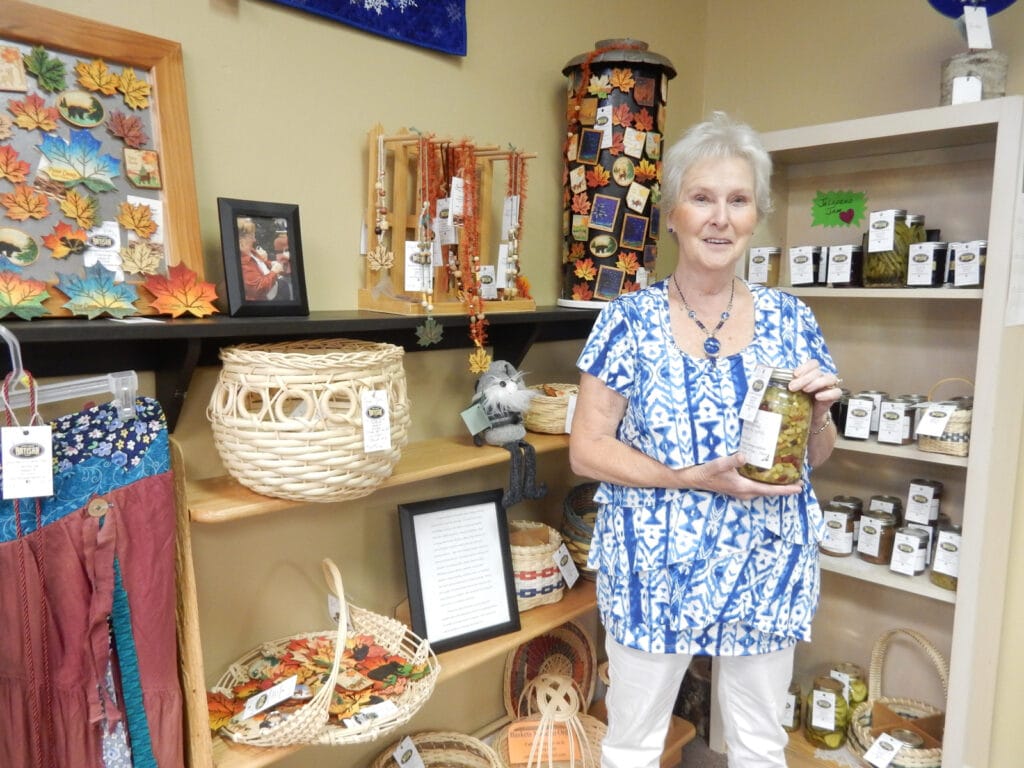 woman holding homemade jarred pickles 