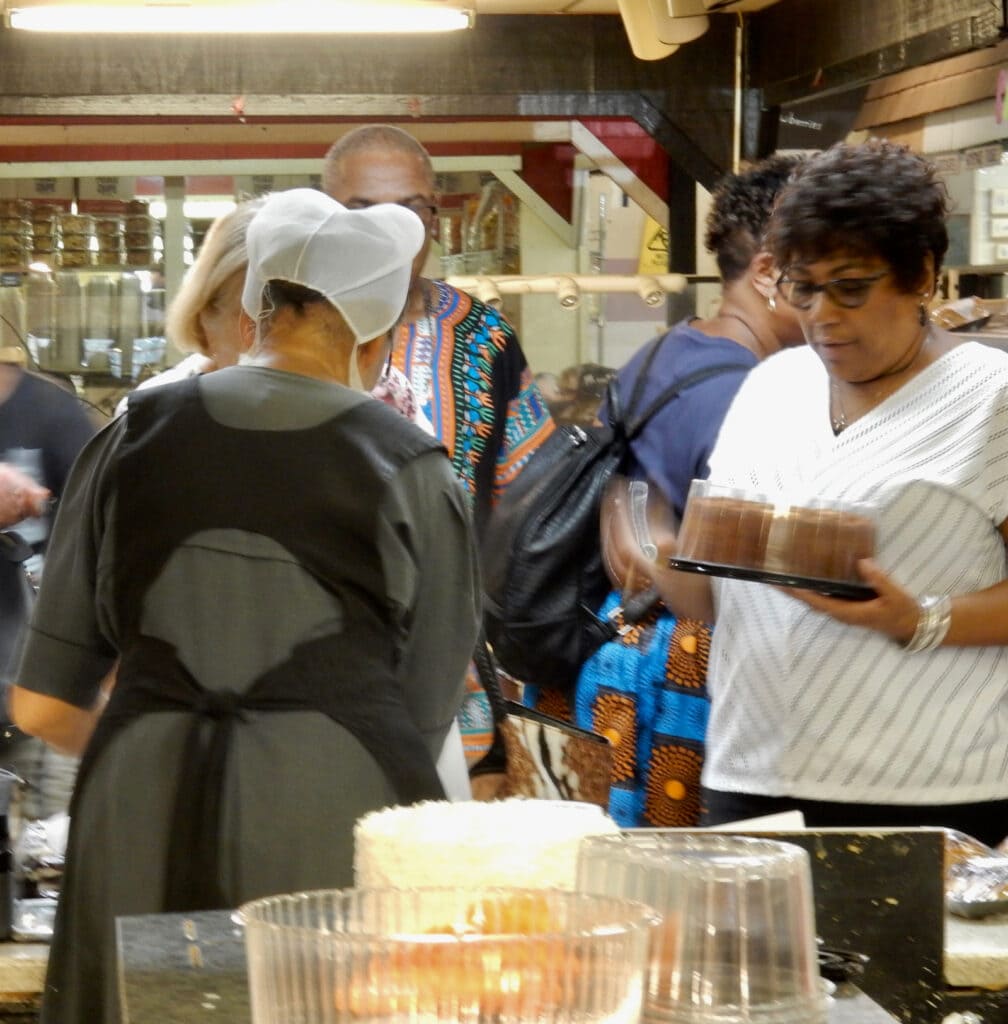 Amish woman serves baked goods at Spence's Bazaar Amish Market Dover DE