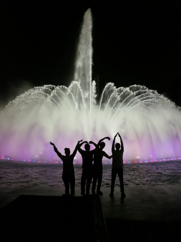 Images silhouetted in front of illuminated fountain Parque De La Reserva Lima Peru 