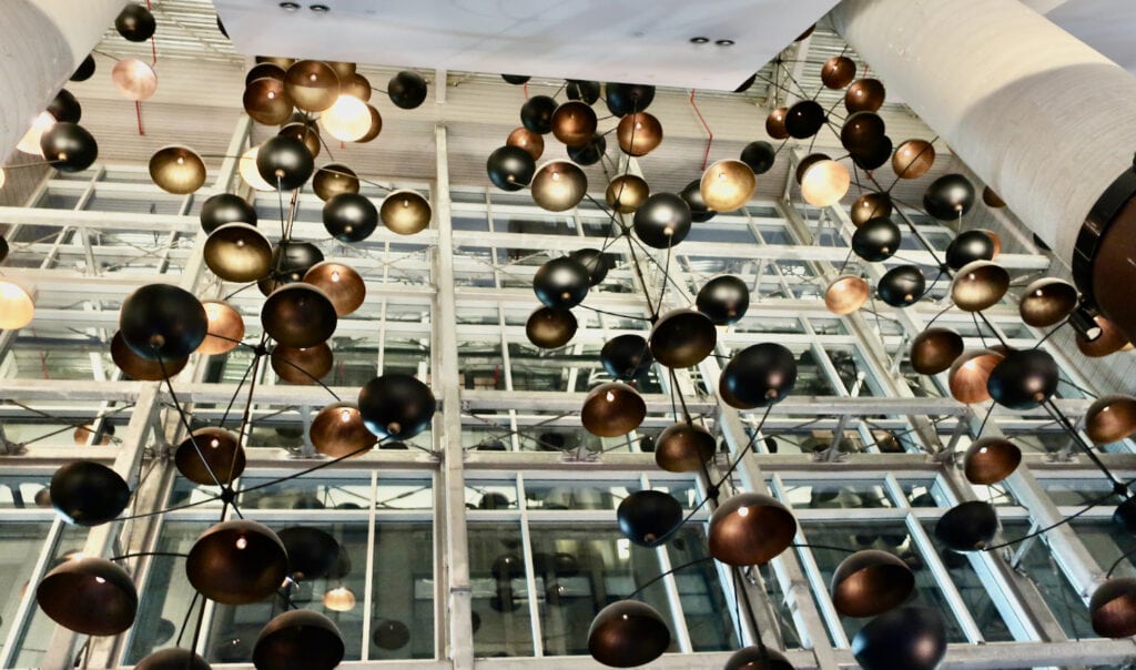Artful 4-story overhead lighting at Crowne Plaza HY36 NYC