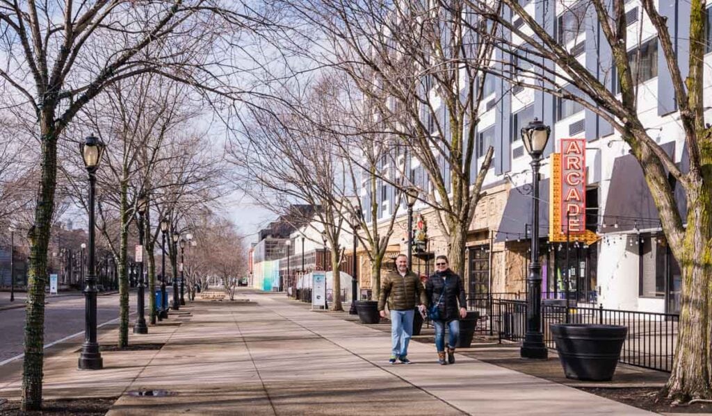 Couple strolling tree lined Old Falls Street in Niagara Falls NY