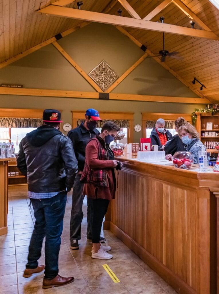 Masked customers make a purchase at Schultze Winery.