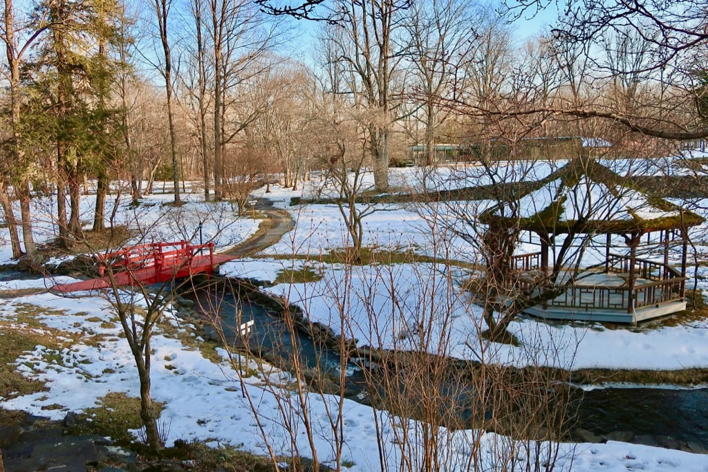 Red footbridge over Troutbeck's stream in winter