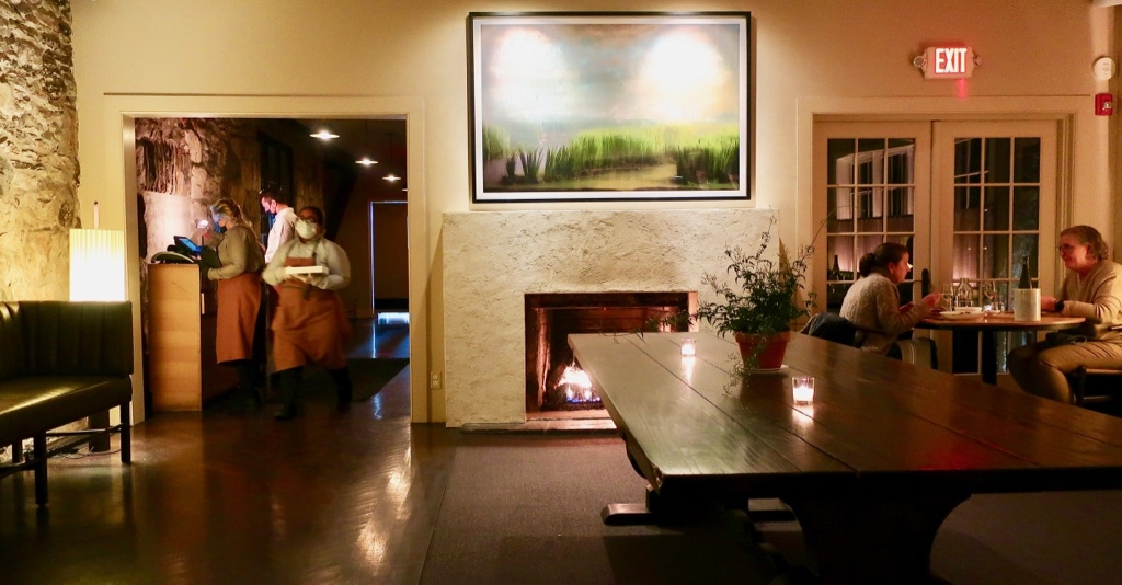 Troutbeck restaurant with evening wait staff and fireplace