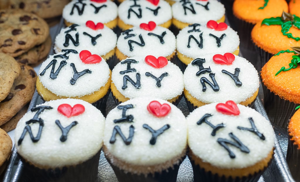 Tray of cupcakes with white icing that reads "I Love NY."