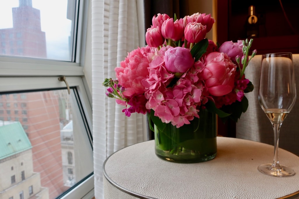 Flowers and glass of Champagne at The Langham Hotel