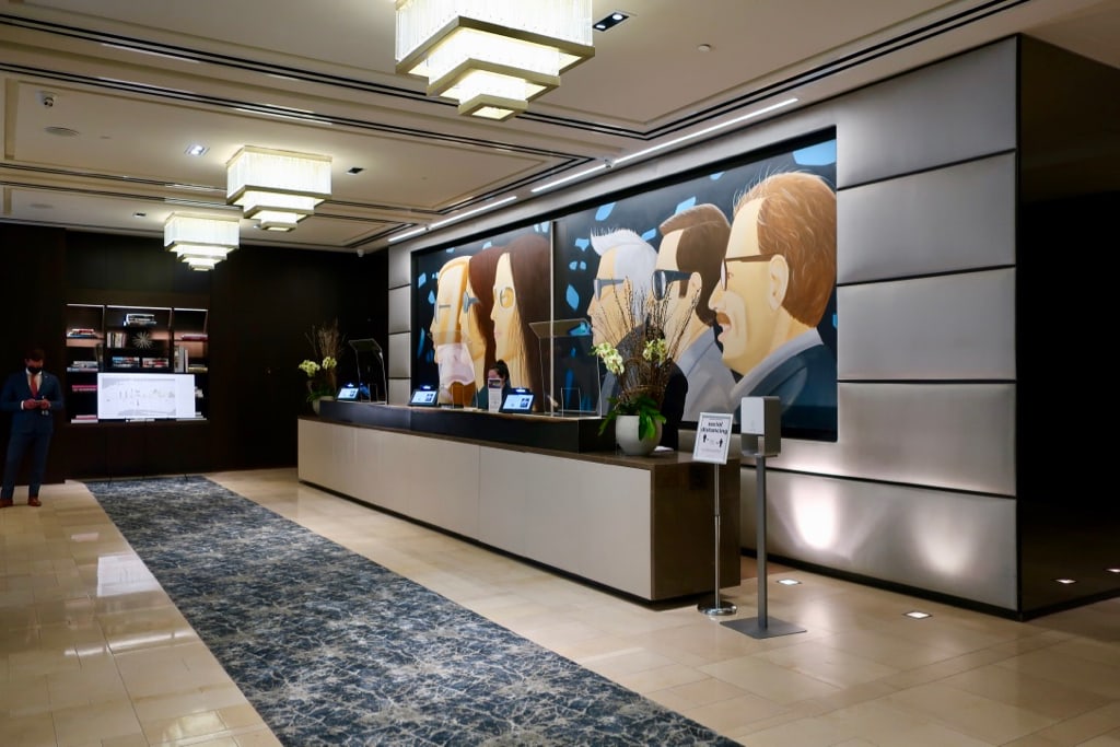 Lobby at The Langham with Alex Katz mural behind reception