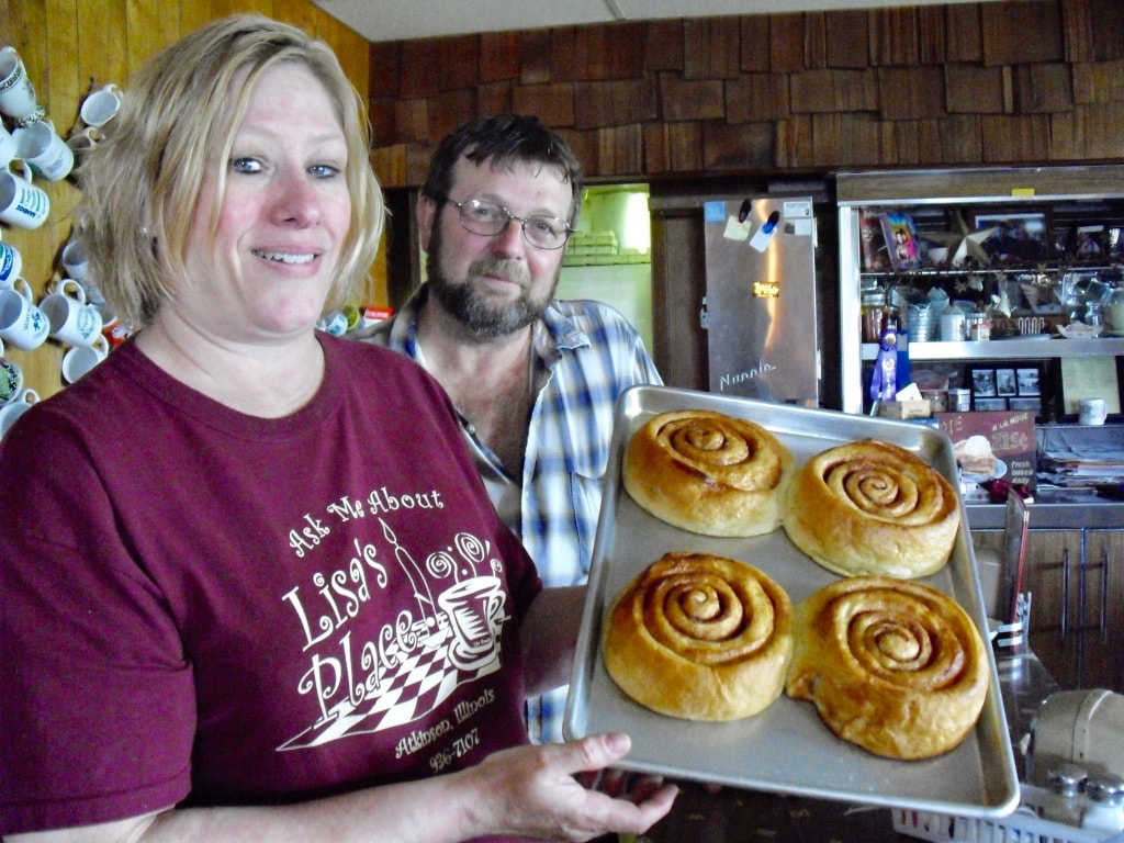 Lisa holding fresh baked cinnamon rolls at Lisas Place Atkinson IL 