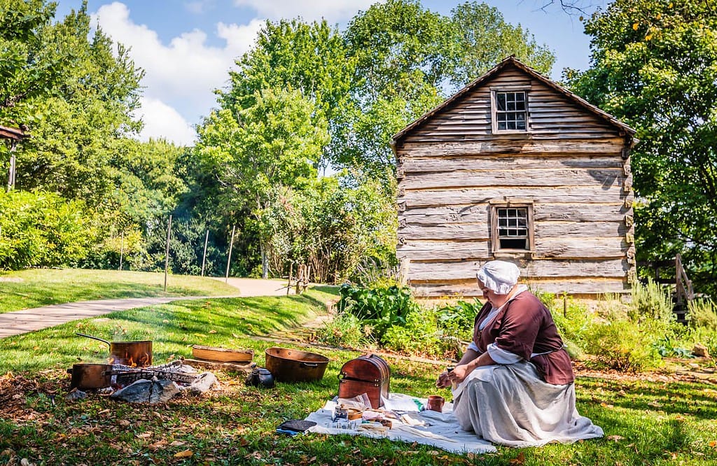 Woman dressed in period clothing demonstrates colonial crafts at Rocky Mount State Historic Site.