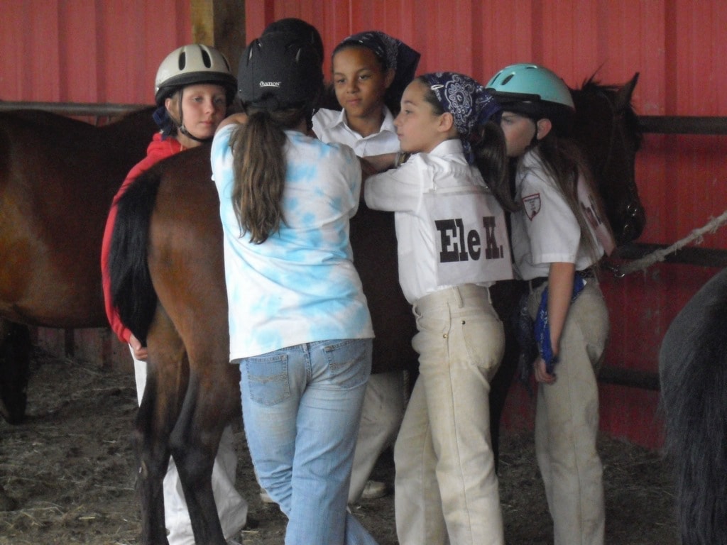 Young Westernaires converse over pony prior to practice 