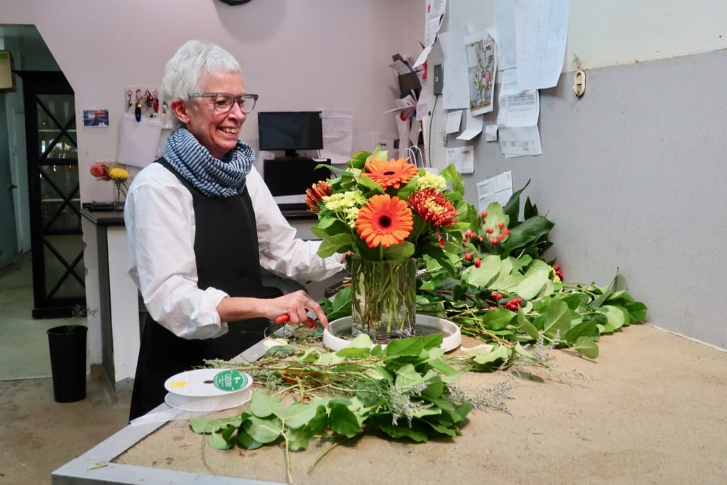 Charlotte Hennegan preparing a floral arrangement New London CT