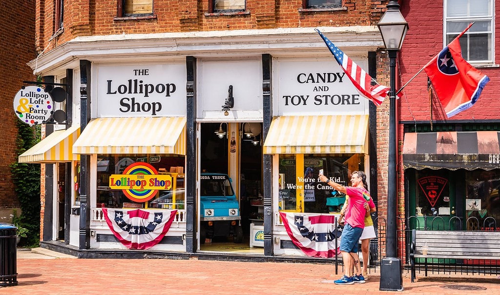 Couple captures selfie in front of The Lollipop Shop in Jonesborough.