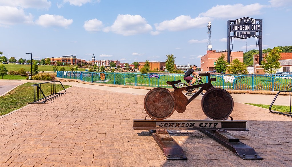 Biker passes Johnson City bike sculpture at King Commons.