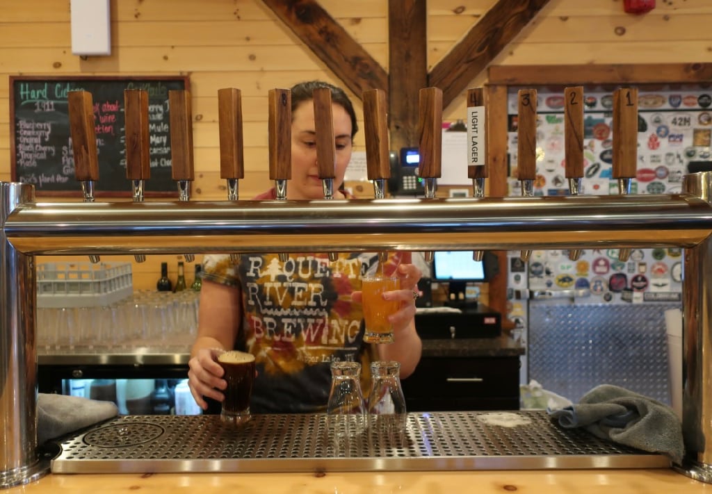 Pouring a beer flight at Raquette River Brewery Tupper Lake NY