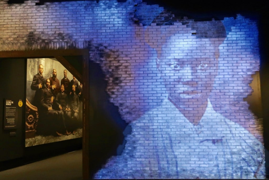 Black congressmen juxtaposed with projection of enslaved woman at American Civil War Museum Richmond