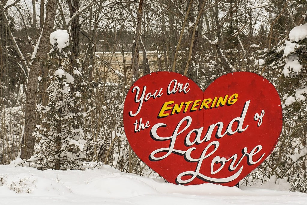 Land of Love sign surrounded by snow.