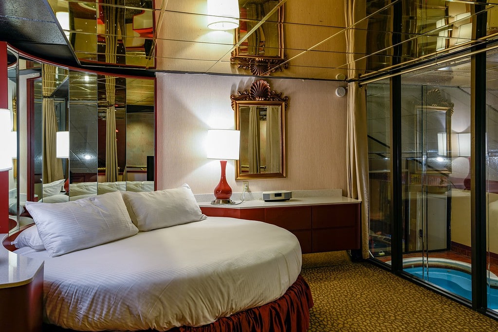 Pocono Palace guest room features. round bed, mirrored ceiling,  and overlooks pool.