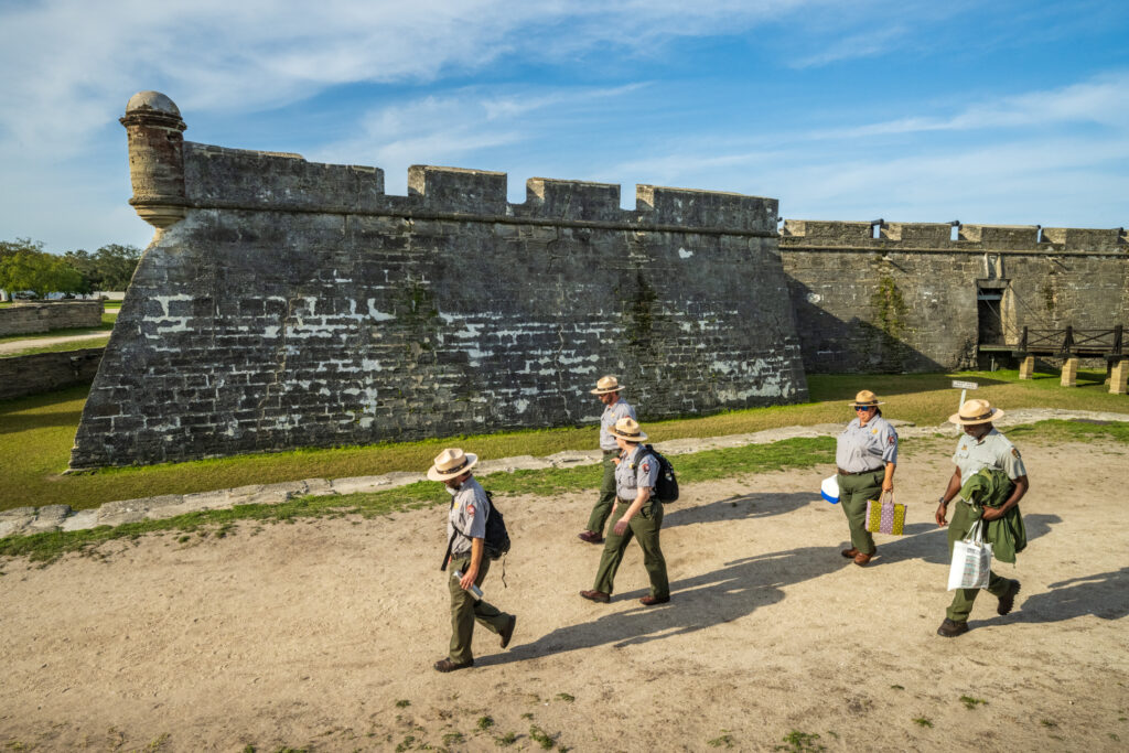 Park rangers walking by Castillo de san Marcos
