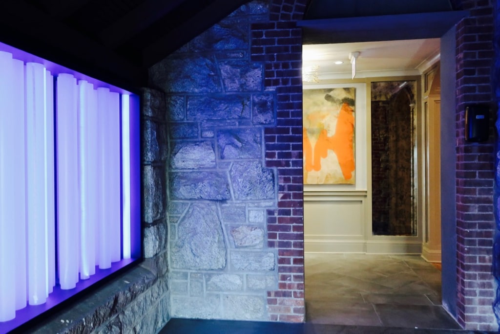 Blue neon light art juxtaposed with contemporary painting at Abbey Inn and Spa NY