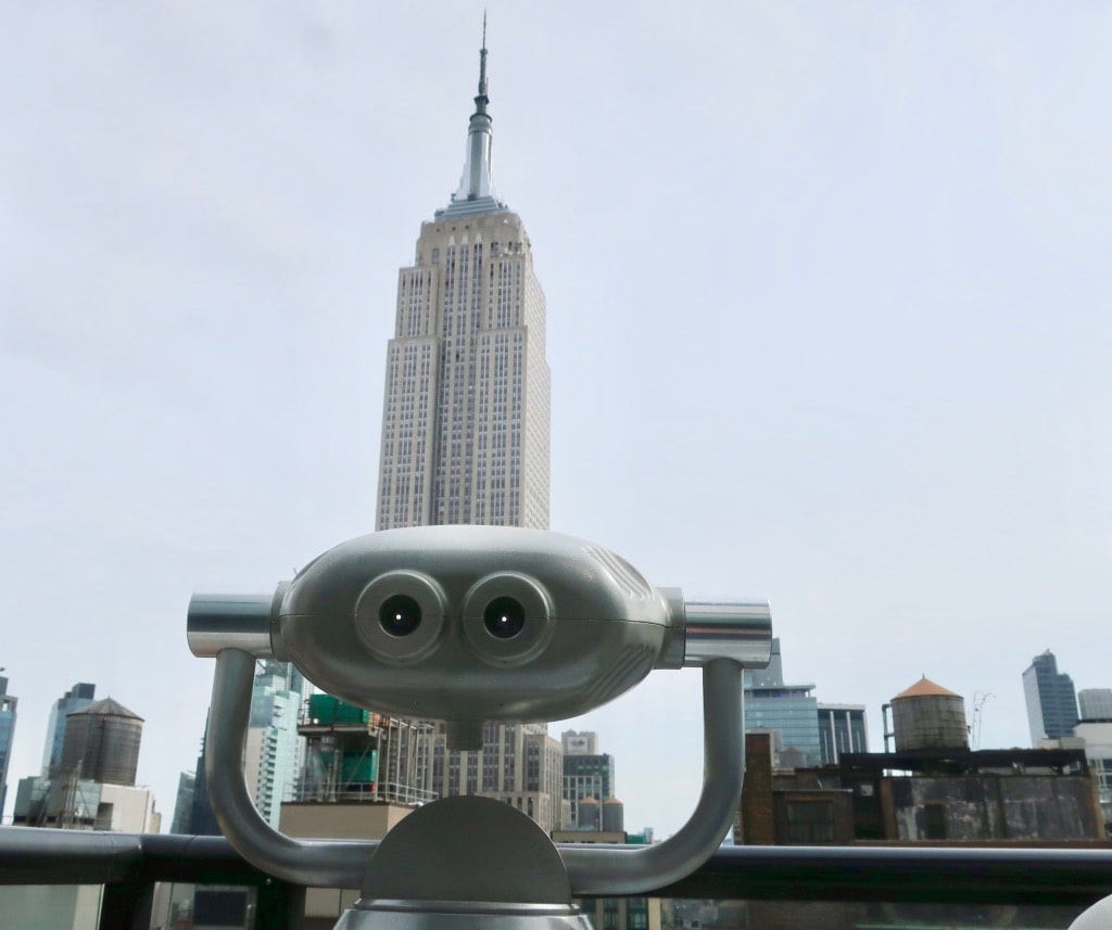 Binocular pointed at Empire State Building at Spyglass Rooftop Bar at Archer Hotel 