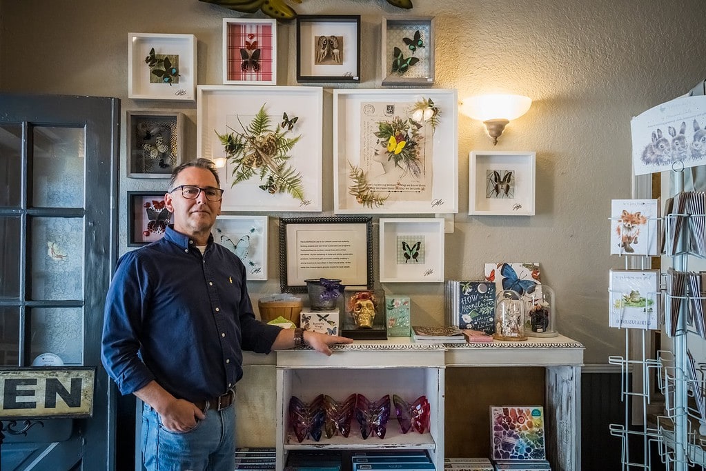 Joel  Mass stands with a display of his Butterfly Artwork at the entrance of Papilio in  Mount Dora.
