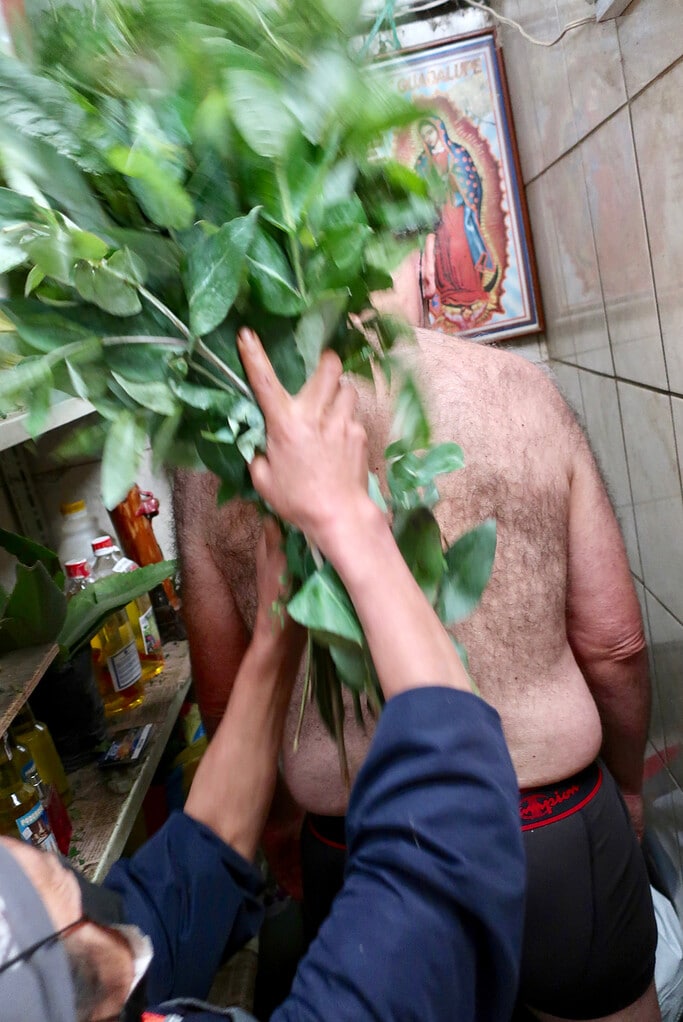 Shaman, Carmen, whips client into balance at Mercado Santa Clara Quito